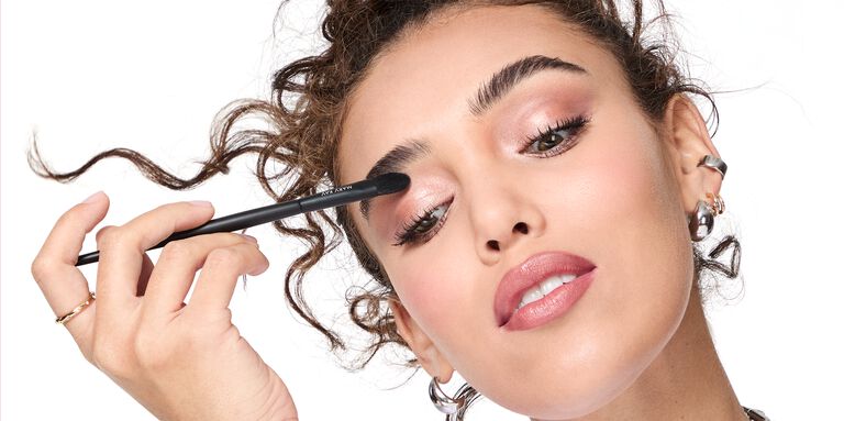 Model blending eyeshadow on her eyelid