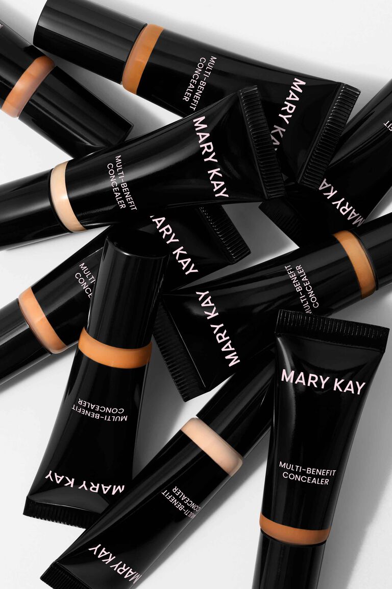 Tubes of Mary Kay Multi-Benefit Concealer stacked on each other against a white background
