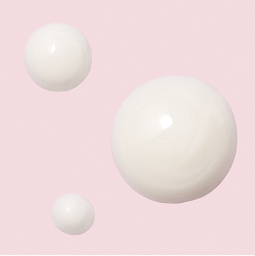 Droplets of Mary Kay Vitamin C+E Serum on pink background